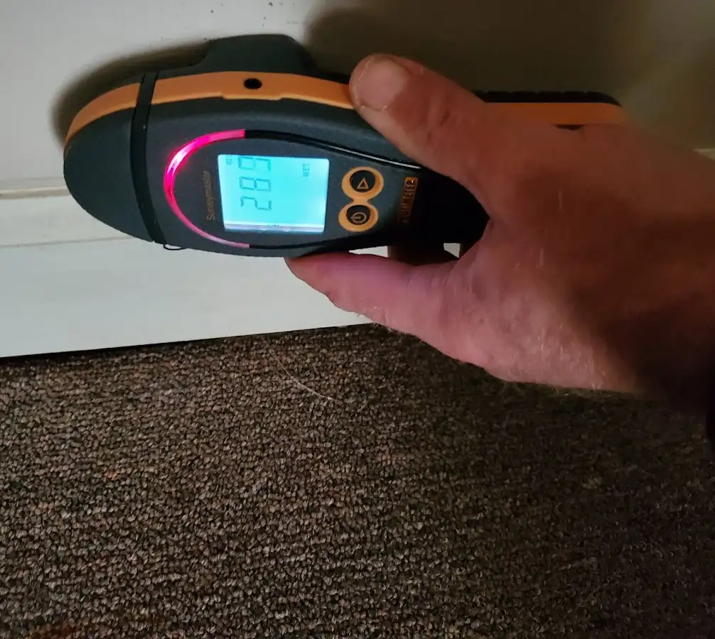 Moisture detection at baseboard during Storm Damage Restoration in Okeechobee